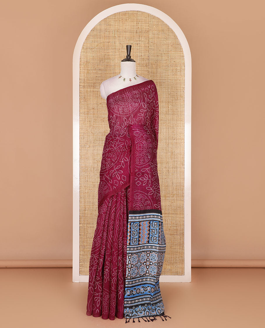 Borderless wine bandhani style floral, paisley, and chakra printed semi-jute silk saree, contrast ajrakh printed pallu, and ajrakh printed blouse