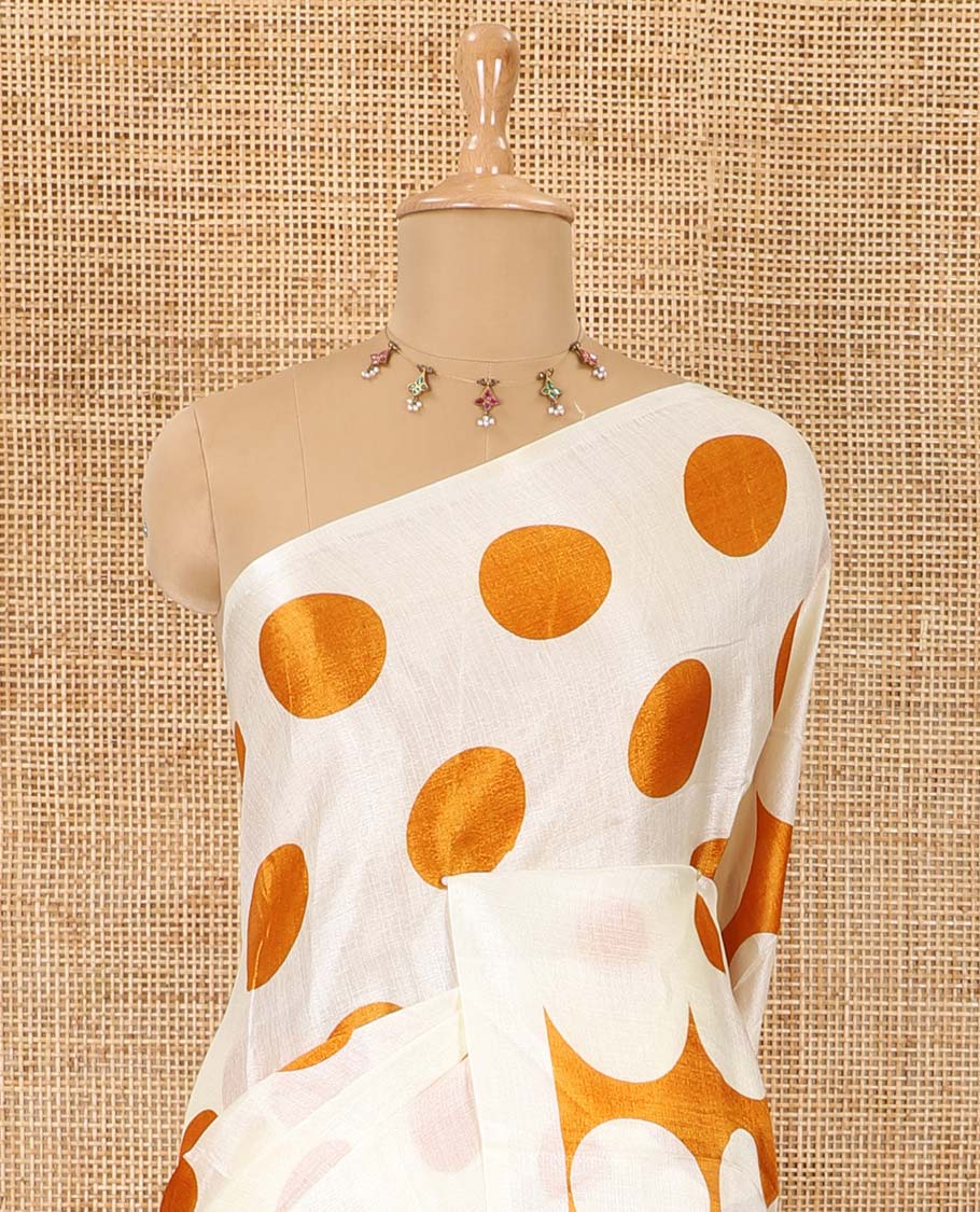 Borderless cream and orange polka dots printed art khadi cotton saree, pallu steeped with polka dots, and a contrast tiny polka dots printed blouse