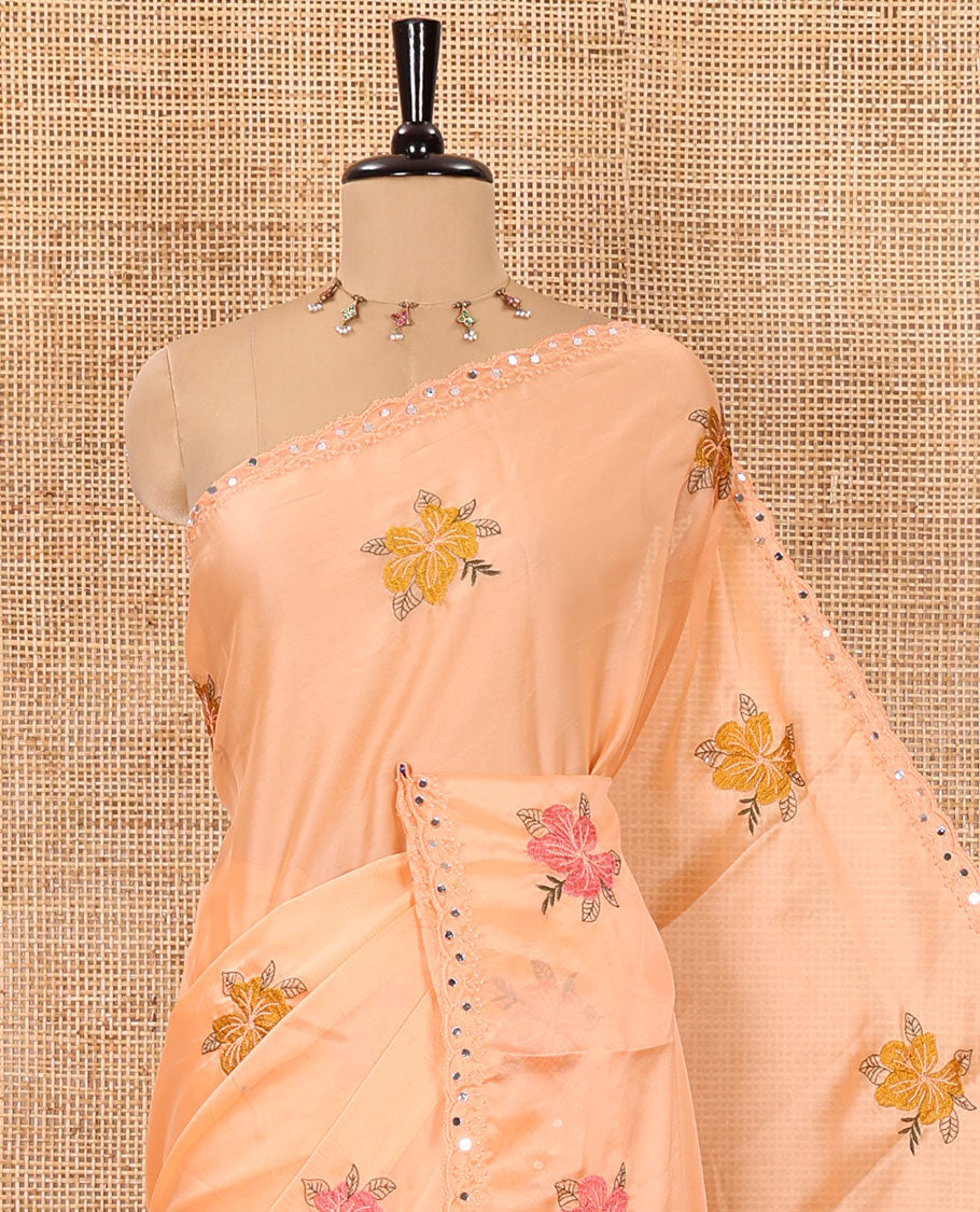 Orange floral motifs embroidered rangoli chiffon saree with mirror work border, embroidered pallu, and a contrast intricate scallop design embroidered blouse