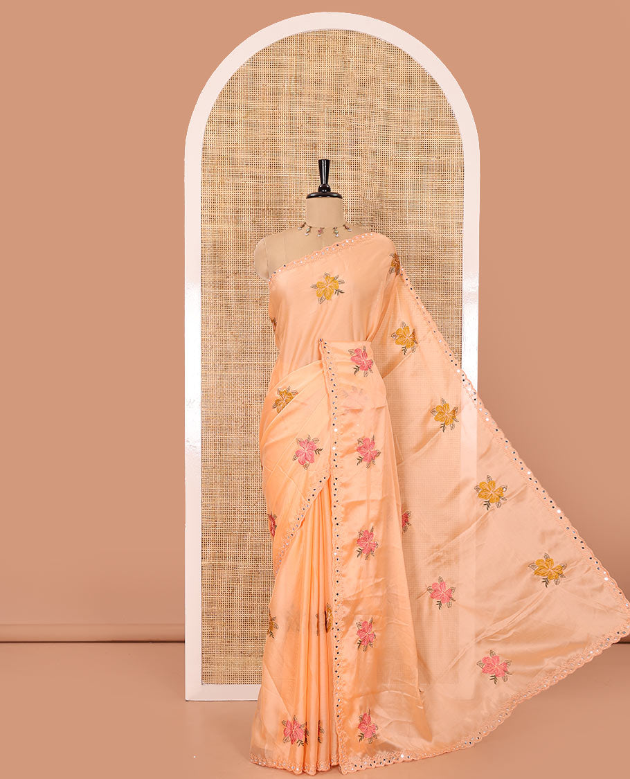 Orange floral motifs embroidered rangoli chiffon saree with mirror work border, embroidered pallu, and a contrast intricate scallop design embroidered blouse