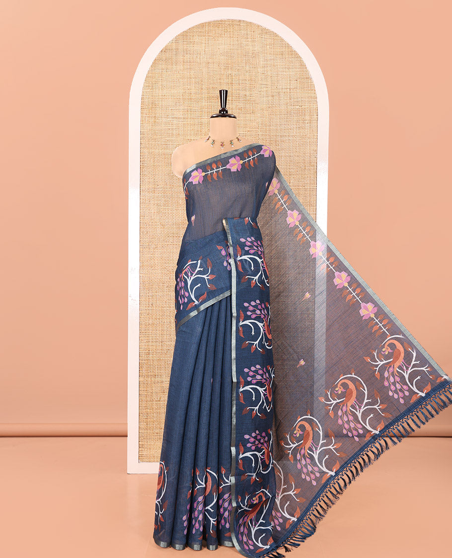 Blue Linen Cotton Saree, Adorned with Floral Motifs in Its Body, Highlighted by a Self-Border of Floral and Peacock Print, Pallu of Peacock Print, and Paired with a Matching Printed Blouse
