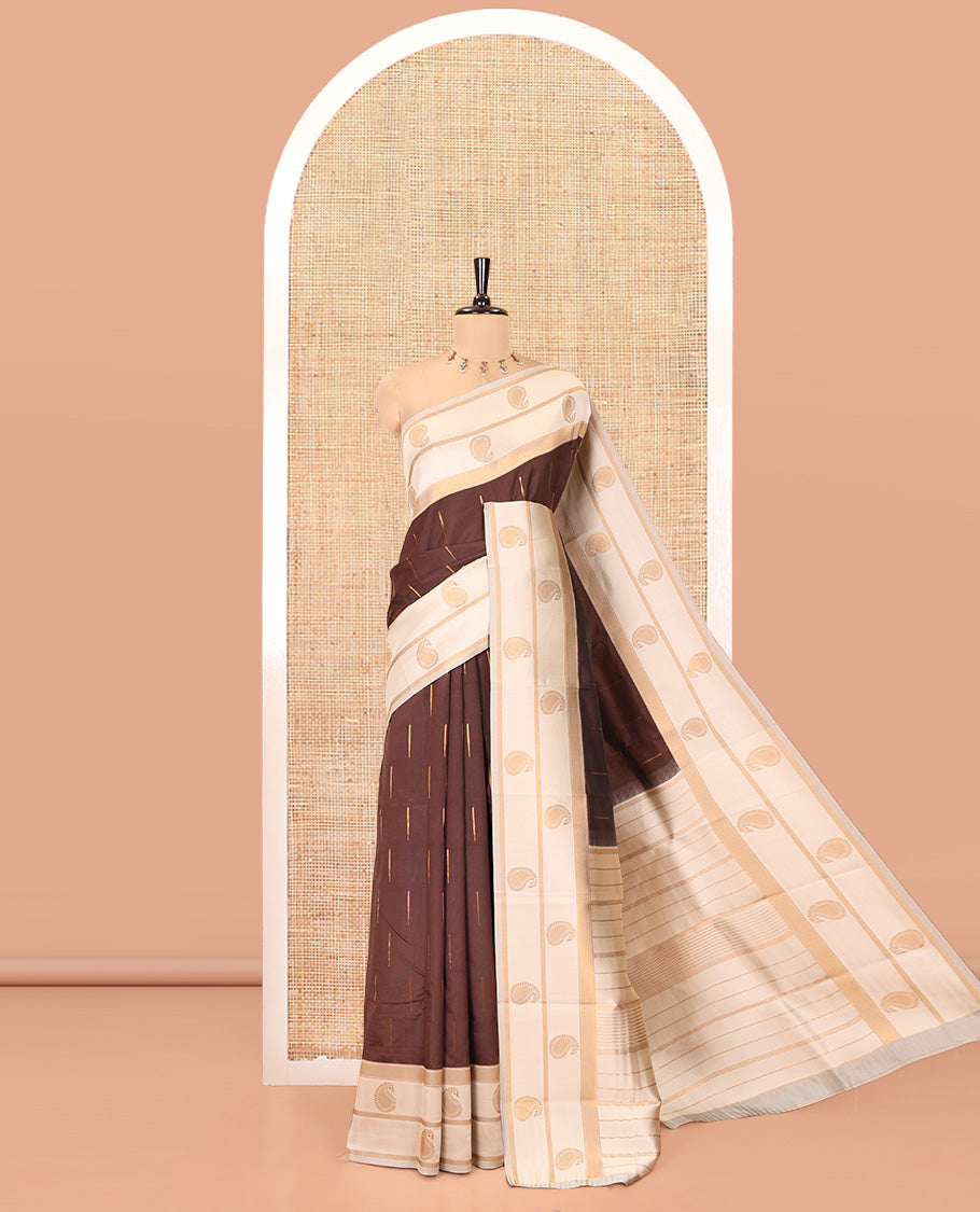 Brown and Cream Kanchi Silk Saree, Bedecked with Zari Buttas All Over Its Body, Complemented by a Contrast Border of Paisleys, Zari-Striped Pallu, and Paired with a Contrast Jacquard Blouse