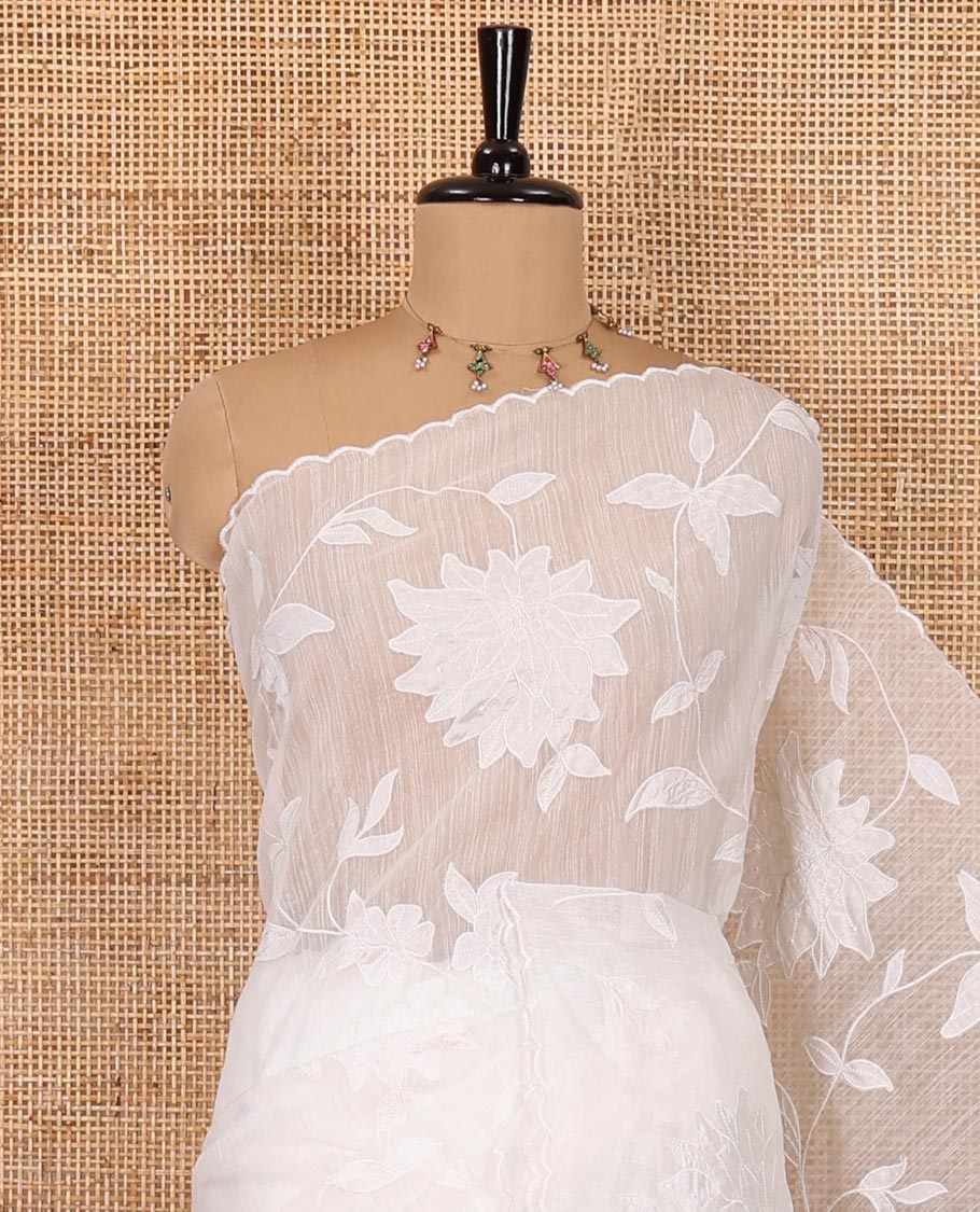 White floral vine applique embroidered linen saree, scallop border, floral motifs embroidered pallu, and a plain blouse