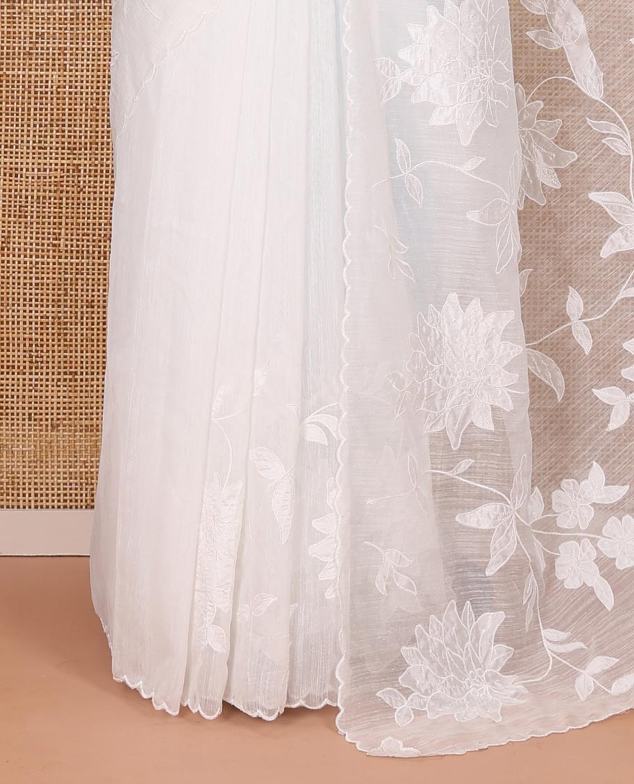 White floral vine applique embroidered linen saree, scallop border, floral motifs embroidered pallu, and a plain blouse