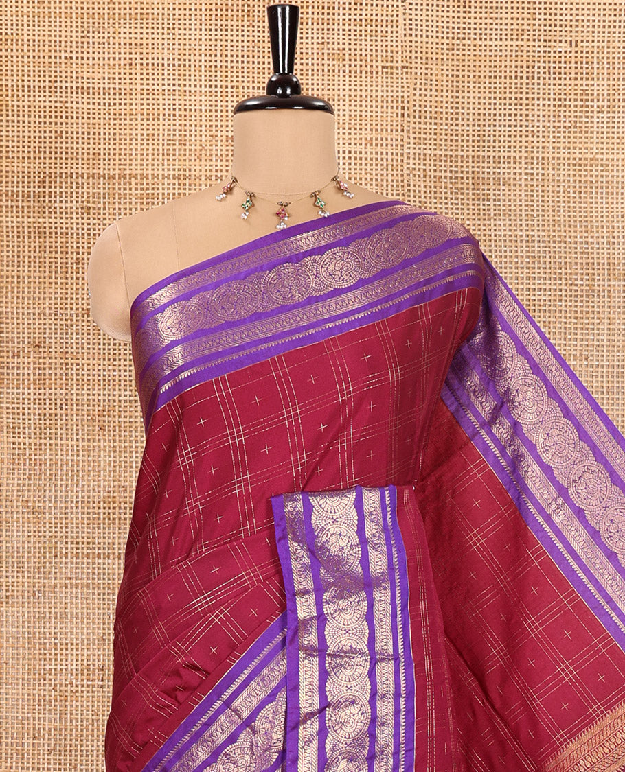Maroon Kanchipuram Budget Silk Saree, Ornamented with Plus-Sized Butta Enclosed Checks All Over Its Body, Complemented by a Contrast Traditional Zari Border of Round Peacock Designs, Pallu Steeped with Circle Motifs, and Paired with a Contrast Blouse