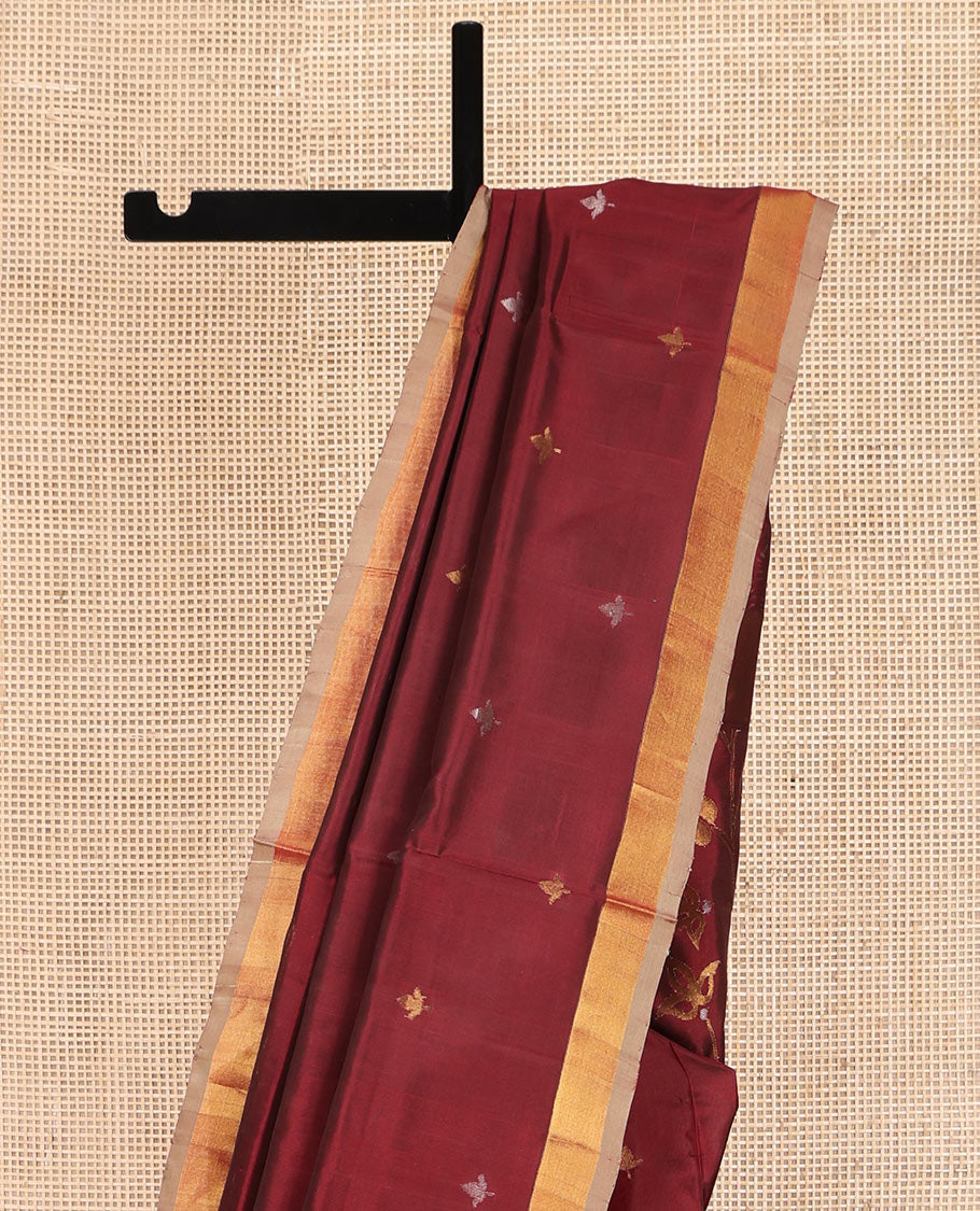 Maroon Uppada Silk Saree, Adorned with Zari Buttas All Over Its Body, Complemented by a Contrast Plain Border, Pallu Features Floral Jaal Designs, and Paired with a Matching Blouse