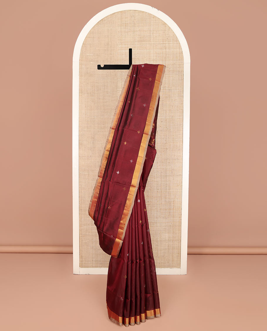 Maroon Uppada Silk Saree, Adorned with Zari Buttas All Over Its Body, Complemented by a Contrast Plain Border, Pallu Features Floral Jaal Designs, and Paired with a Matching Blouse