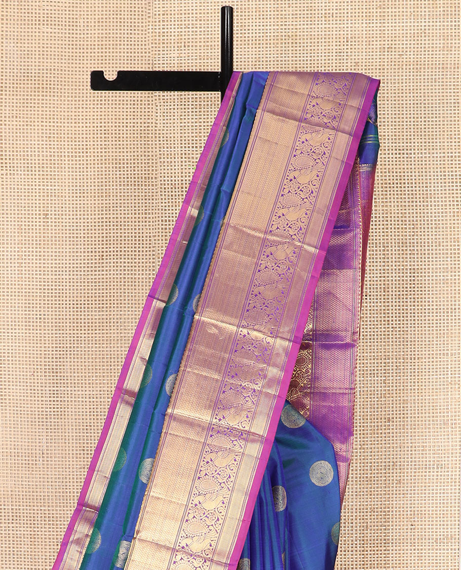 Blue Vasundhara Silk Saree Richly Detailed with Round Mayil Buttas, Highlighted with a Contrast Border of Muthu, Mayil Kann, and Mayil Designs, Grandly Zari Woven Pallu of Jaal Design, and Paired with a Contrast Blouse
