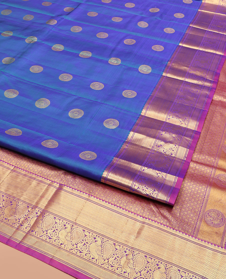 Blue Vasundhara Silk Saree Richly Detailed with Round Mayil Buttas, Highlighted with a Contrast Border of Muthu, Mayil Kann, and Mayil Designs, Grandly Zari Woven Pallu of Jaal Design, and Paired with a Contrast Blouse