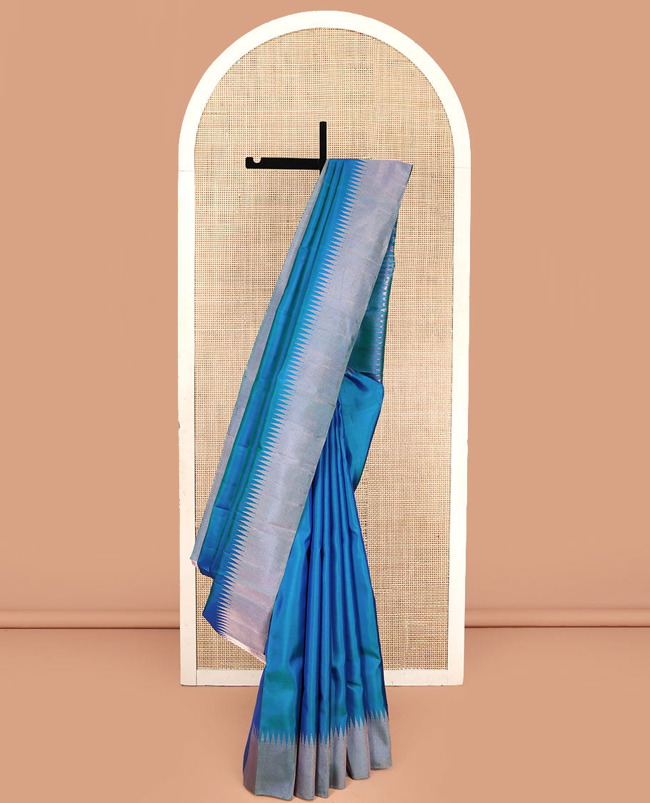 Blue Plain Vasundhara Silk Saree, Highlighted by Thazampoo Rekku Zari Border, Pallu of Mayil Kann, and Yaali Designs, and Paired with a Matching Blouse