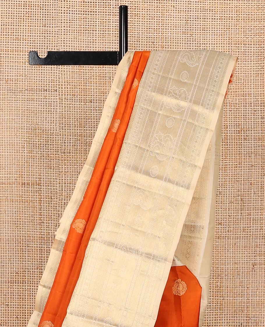 Orange zari buttas silk saree, contrast mayil kann pallu & border of thilakam,kathir,rudraksham,mayil kann & annam chakram