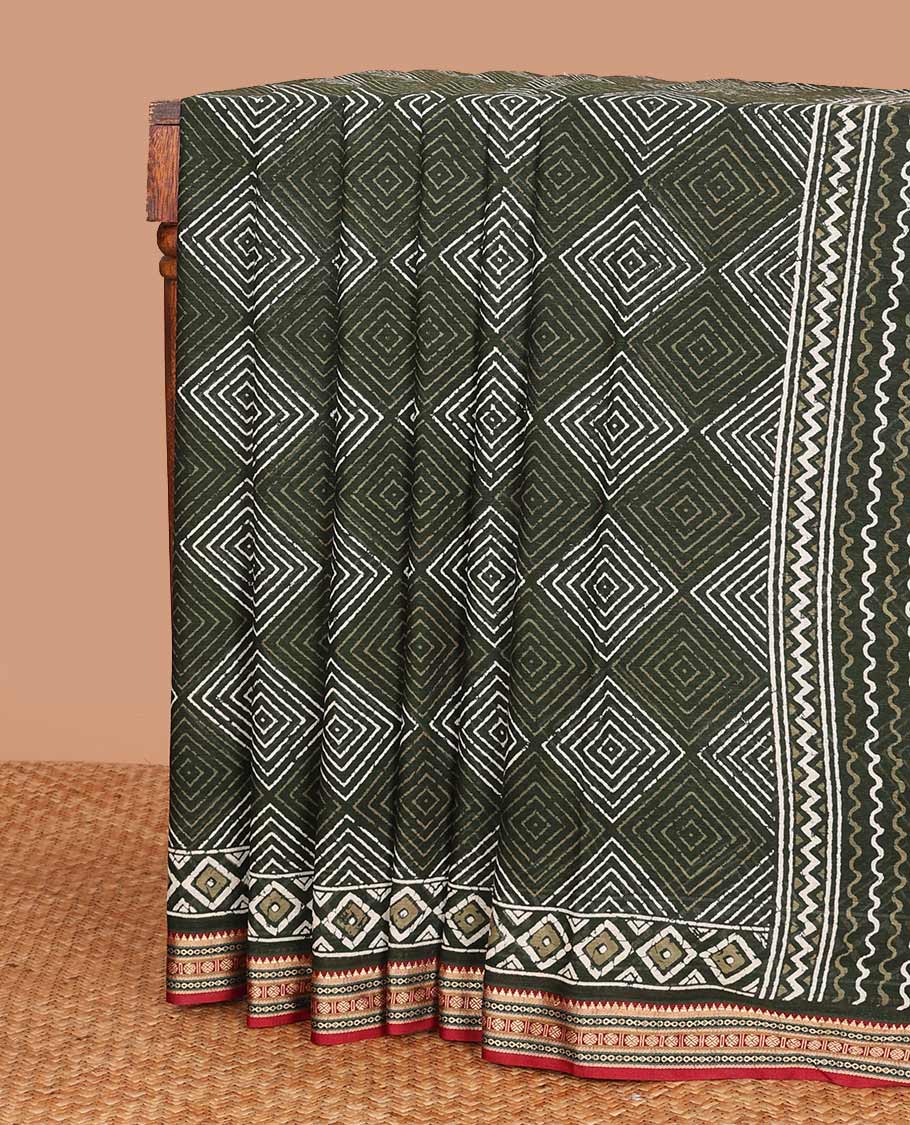 Green batik style argyle printed mul mul cotton saree, contrast traditional motifs border, and pallu of geometric and paisley print