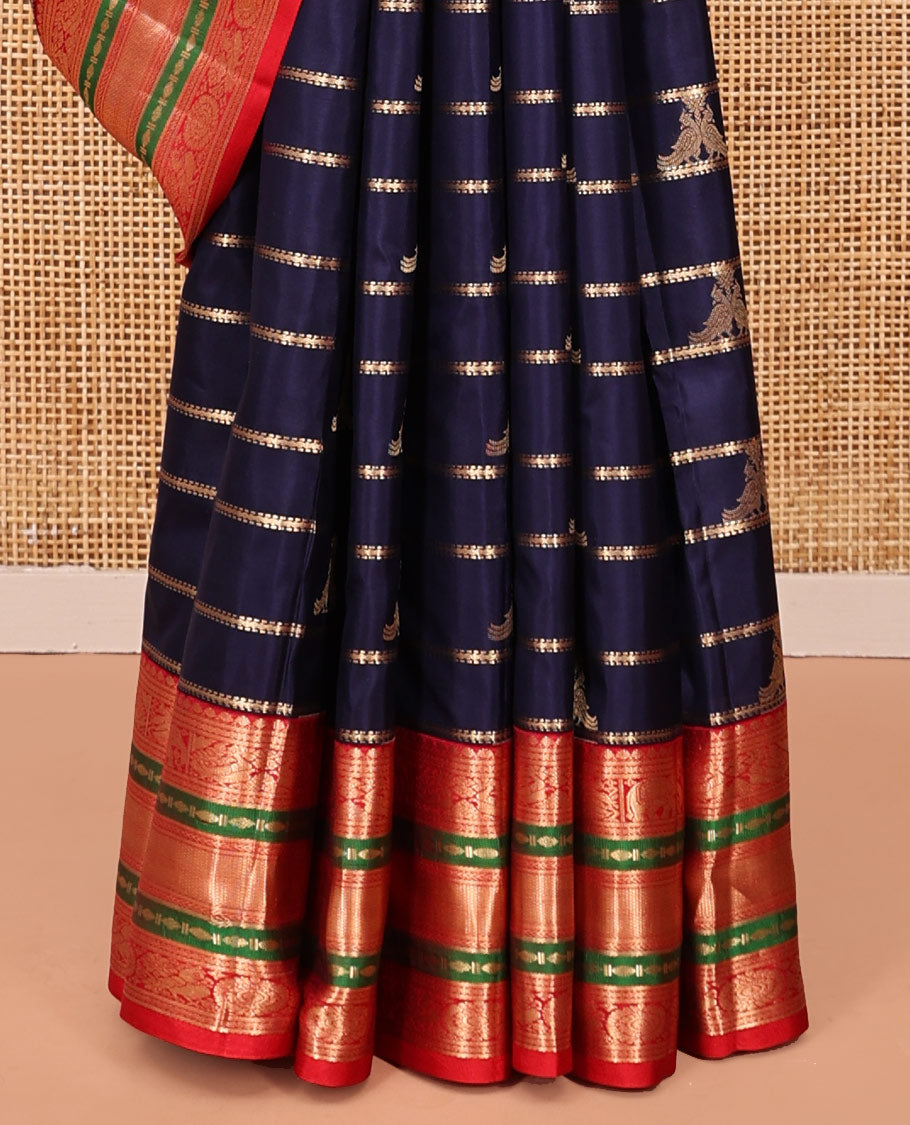Blue Vasundhara Silk Saree, Accentuated with Zari Buttas and Stripes All Over Its Body, Complemented by a Contrast Border of Elephant, Mayil, and Chakram Designs, a Grand Pallu, and Paired with a Contrast Blouse