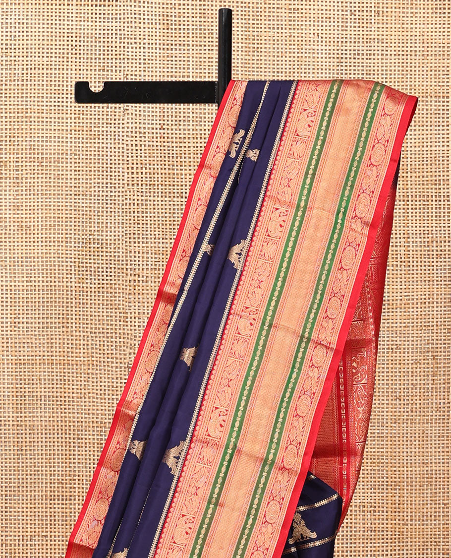 Blue Vasundhara Silk Saree, Accentuated with Zari Buttas and Stripes All Over Its Body, Complemented by a Contrast Border of Elephant, Mayil, and Chakram Designs, a Grand Pallu, and Paired with a Contrast Blouse