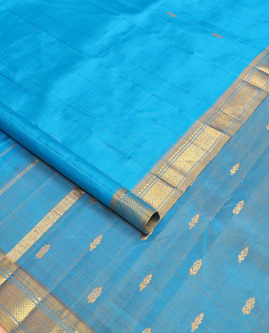 Blue kanchipuram silksaree with zari buttas, contrast one-sided border of rekku & mayil kann & zari design pallu