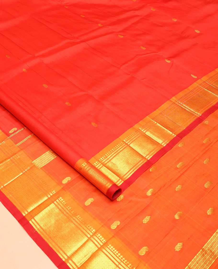 Orange Kanchipuram Silk Saree, Bedecked with Zari Buttas All Over Its Body, Complemented by a Contrast One-Sided Border of Panner Sombu, Banaras, and Mayil Kann Designs, Pallu of Zari Designs, and Comes Without a Blouse