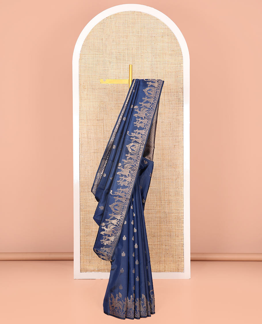Blue Vasundhara Silk Saree Gleamed Up with Zari Buttas All Over Its Body, Highlighted by a Zari Border of Wedding-Themed Bridegroom Designs, Pallu Majestically Detailed with Jaal Designs, and Paired with a Matching Blouse