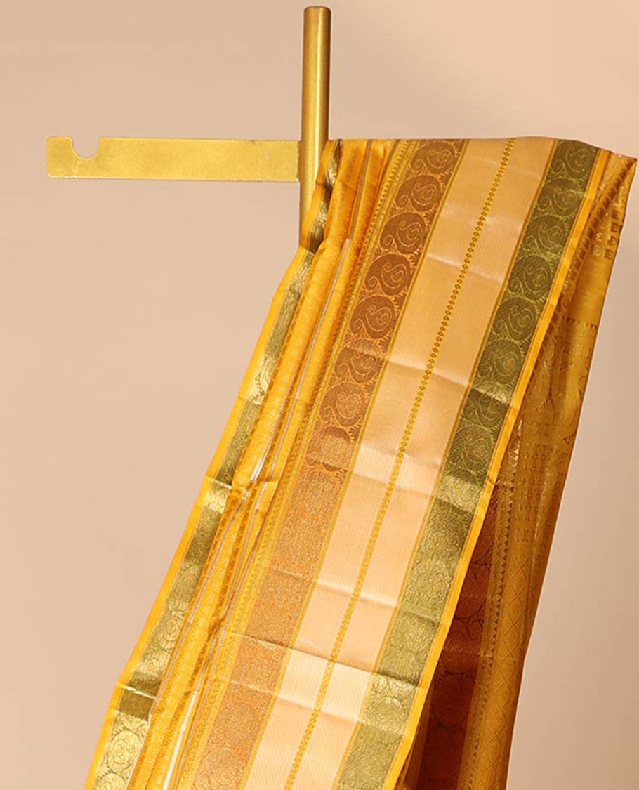 Yellow embossed silk saree with sparkling zari stripes, intricate pallu & zari border of thilakam mokku & manga designs