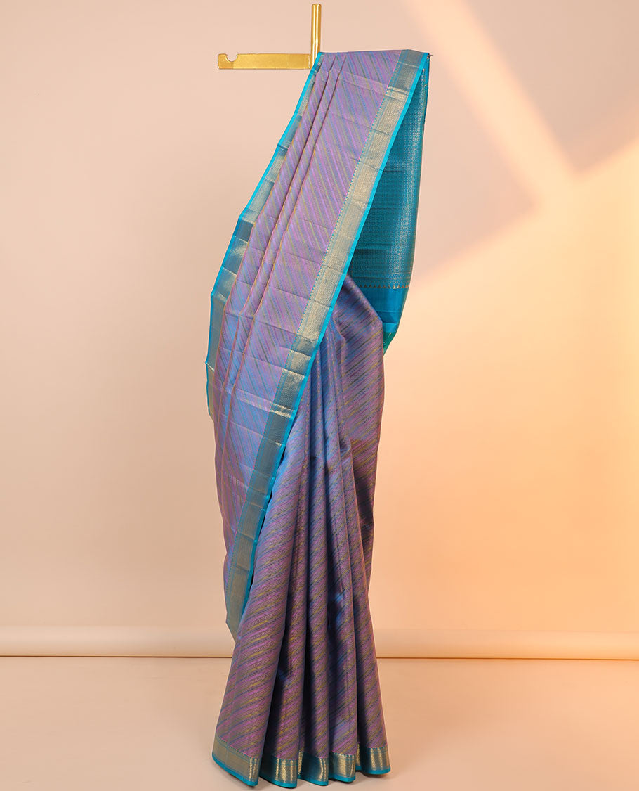 Violet embossed & zari butta silksaree,contrast border of thilakam mokku,muthu & vanki design & pallu of poun