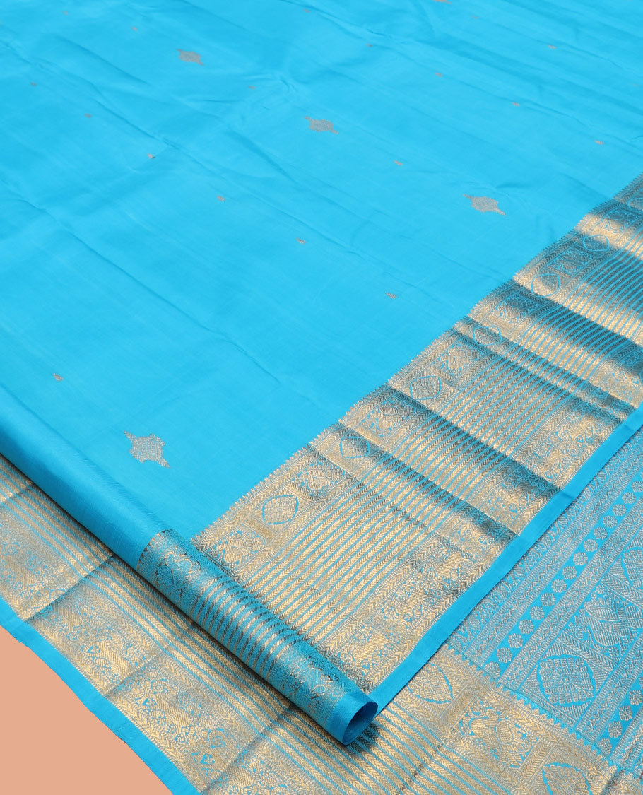 Blue Kanchipuram Silk Saree, Mesmerized with Zari Buttas, Highlighted by Zari Border of Thilakam Mokku, Kathir, Mayil, Chakram, and Yaali, Grand Pallu, and Matching Blouse