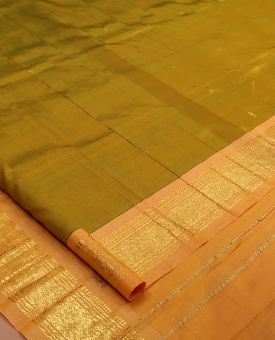 Green Kanchipuram Silk Saree, Accentuated with Zari Buttas, a Contrast One-sided Border of Panner Sombu, Banaras, Muthu, and Jaal Designs, Pallu of Zari Designs, and No Blouse