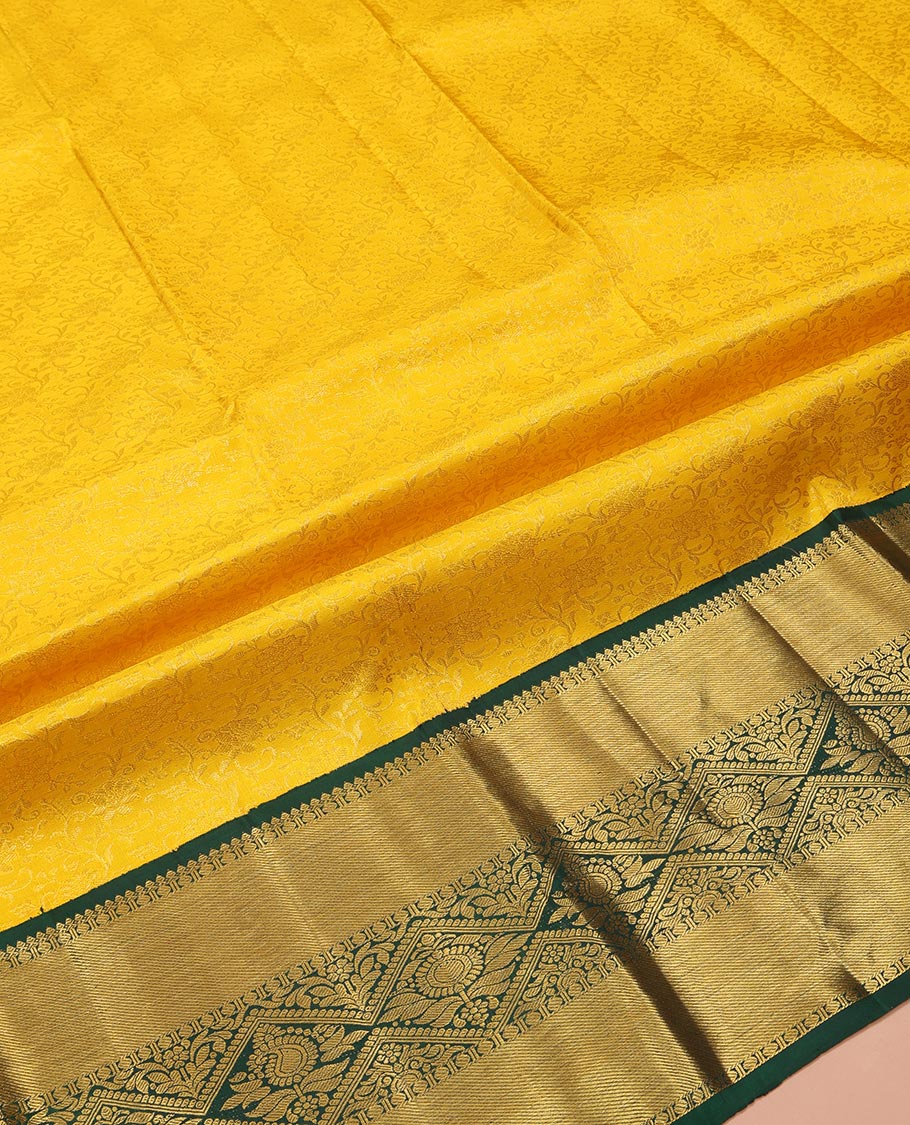 Yellow Pure Silk Half-Saree, Sparsely Woven with Floral Jacquard All Over Its Skirt, Complemented by a Contrast Korvai Border of Thilakam Mokku, Paisa, and Diamond Designs, Paired with a Contrast Blouse, and Comes with a Jaal Design Dhavani