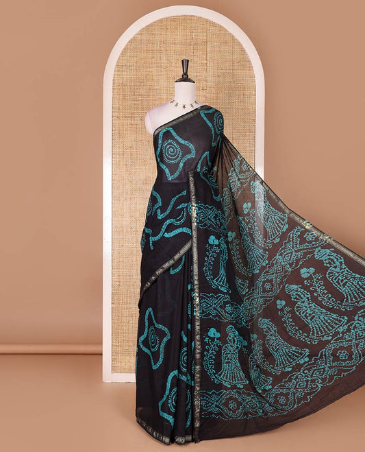 Black-blue batik geometric printed pure cotton saree, zari piping border, human figurines batik printed pallu, and a matching batik printed blouse