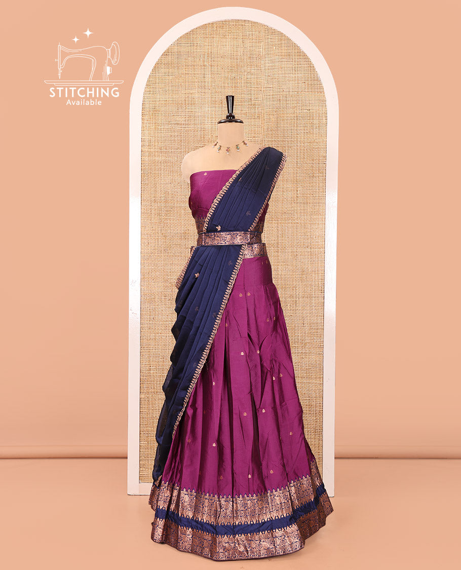 Dark Magenta and Blue Semi-Banarasi Half-Saree, Accentuated with Zari Buttas on Its Skirt, Complemented by a Contrast Rettai Pettu Traditional Zari-Design Border, Paired with a Matching Blouse, and Comes with a Contrast Satin Georgette Embroidered Dhavani