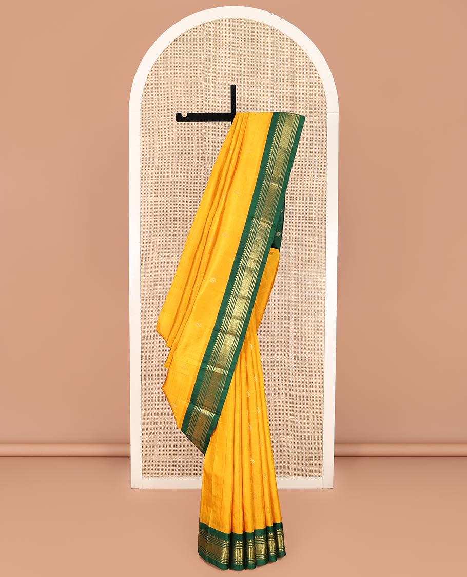 Yellow Kanchipuram Silk Saree, Subtly Sparkled with Zari Buttas on Its Body, Complemented by a Contrast One-Sided Korvai Border of Thazampoo Rekku, Banaras, Muthu, and Jaal Designs, Pallu Features Zari Designs, and Comes Without a Blouse