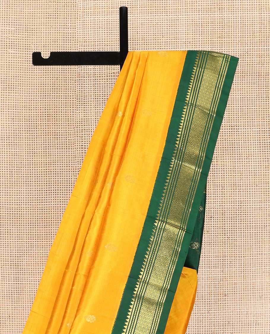 Yellow Kanchipuram Silk Saree, Subtly Sparkled with Zari Buttas on Its Body, Complemented by a Contrast One-Sided Korvai Border of Thazampoo Rekku, Banaras, Muthu, and Jaal Designs, Pallu Features Zari Designs, and Comes Without a Blouse