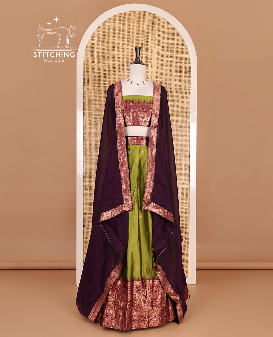 Leaf green taffeta silk half saree, zari buttas with contrast purple traditional zari border, matching zari blouse, and contrast plain zari border dhavani