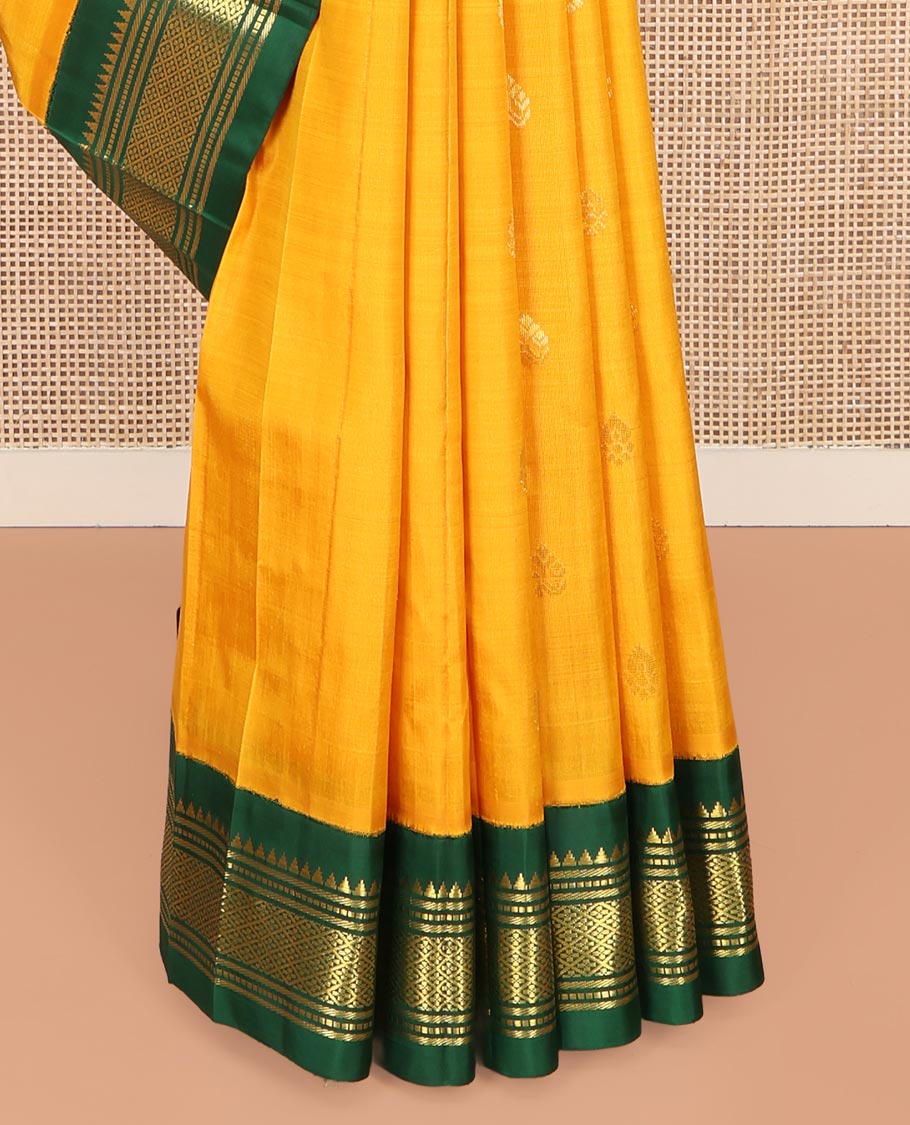 Yellow Kanchipuram Silk Saree, Subtly Sparkled with Zari Buttas on Its Body, Complemented by a Contrast One-Sided Korvai Border of Thazampoo Rekku, Banaras, Muthu, and Jaal Designs, Pallu Features Zari Designs, and Comes Without a Blouse