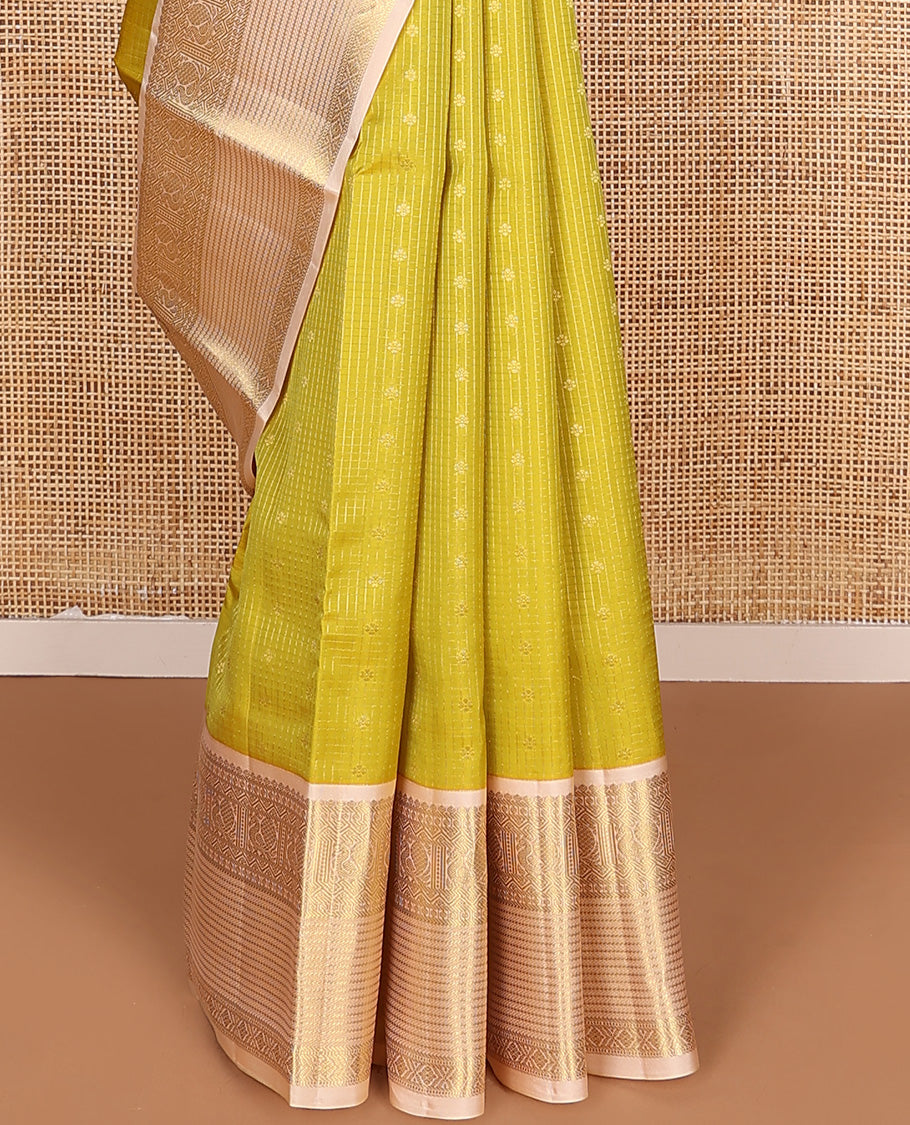 Yellow zari buttas and micro-checked Vasundhara silk mix saree, contrast border of thilakam mokku, banaras, paisa, mayil, banaras, and zari design, and peacock feather motifs pallu