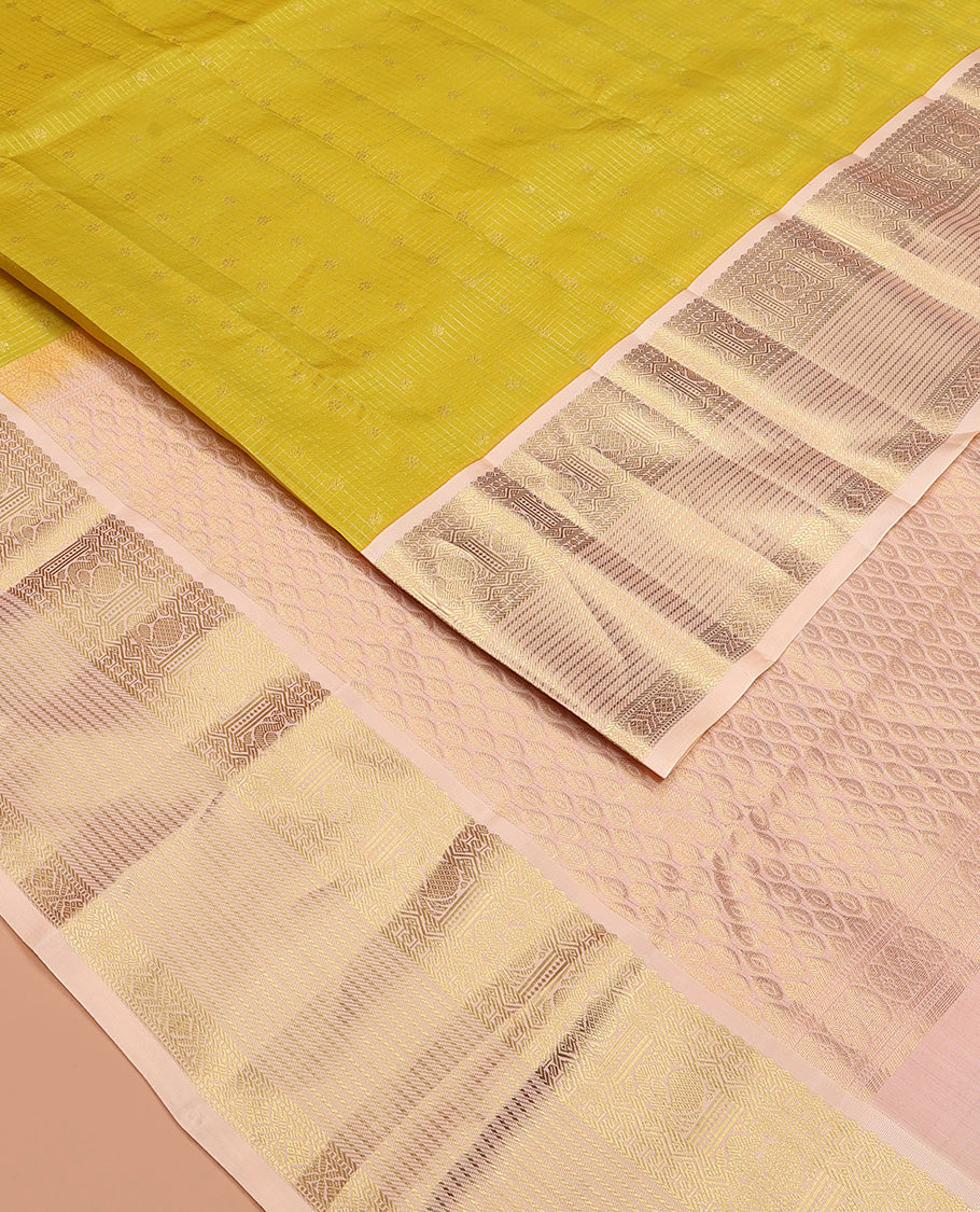 Yellow zari buttas and micro-checked Vasundhara silk mix saree, contrast border of thilakam mokku, banaras, paisa, mayil, banaras, and zari design, and peacock feather motifs pallu