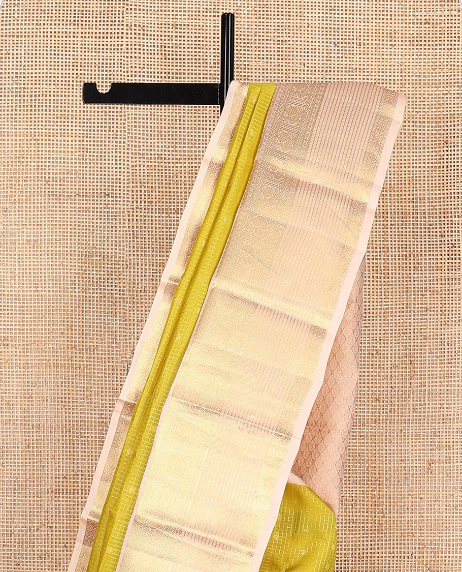 Yellow zari buttas and micro-checked Vasundhara silk mix saree, contrast border of thilakam mokku, banaras, paisa, mayil, banaras, and zari design, and peacock feather motifs pallu