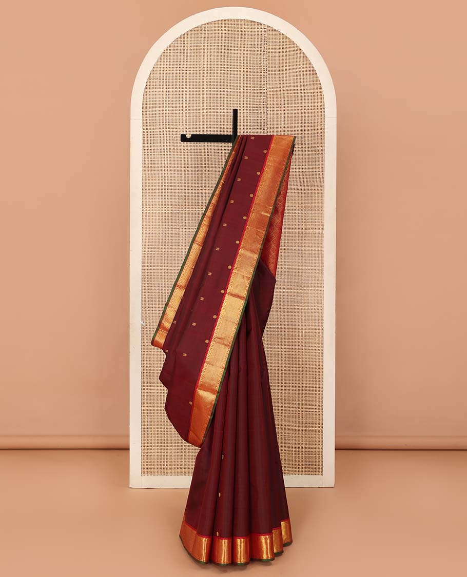 Maroon mayil poun buttas Kanchipuram silk saree, contrast border of rekku, banaras, cross kamalam, and zari stripes, and zari rich jaal pallu