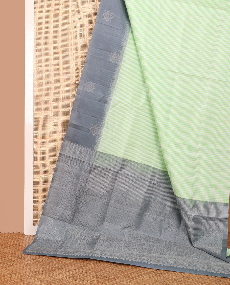 Green micro-checked soft silk saree, contrast kolam butta border & pallu of jaal design