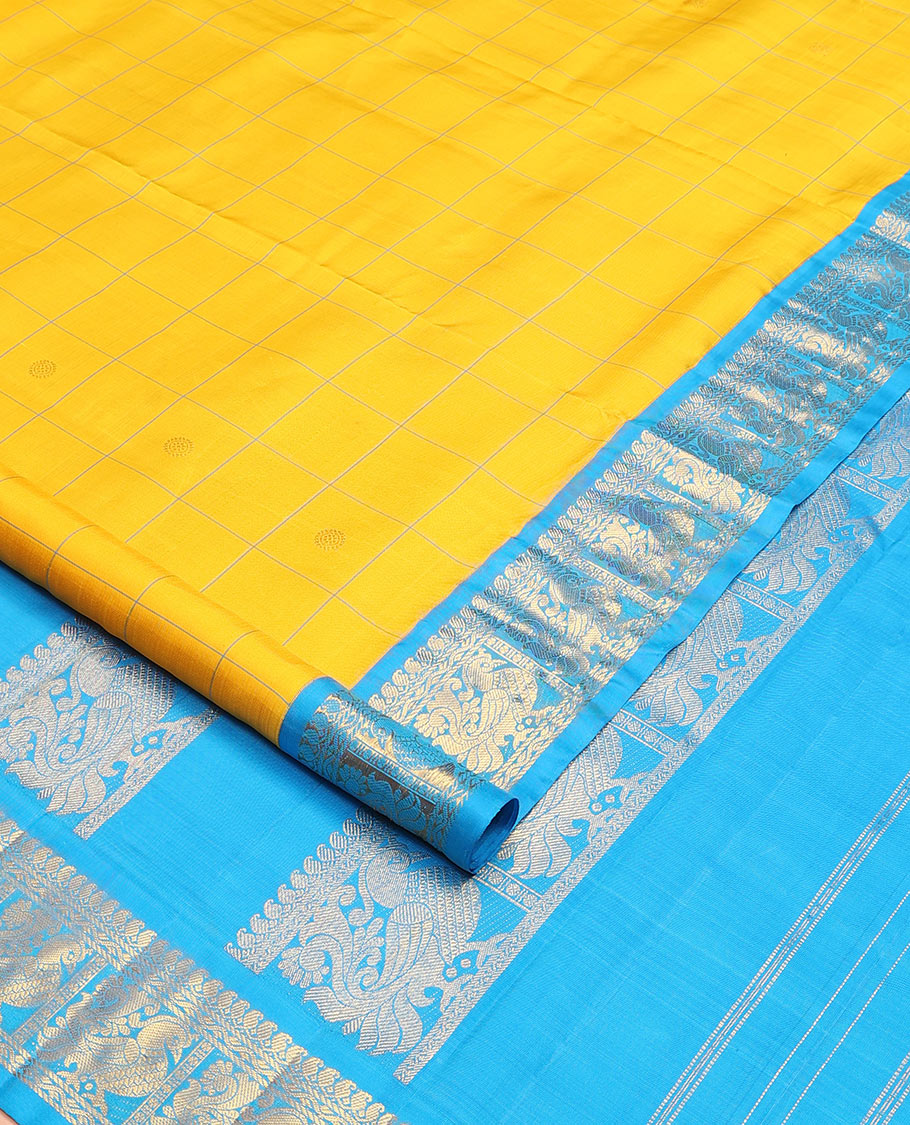 Yellow butta enclosed checked nine-yard silk saree, contrast border of manga mokku, and mayil designs, and pallu of mayil designs