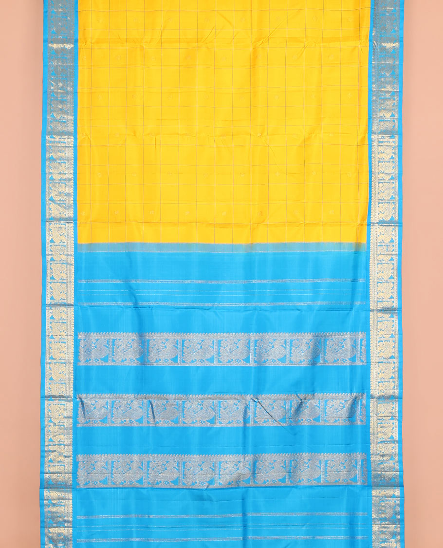 Yellow butta enclosed checked nine-yard silk saree, contrast border of manga mokku, and mayil designs, and pallu of mayil designs