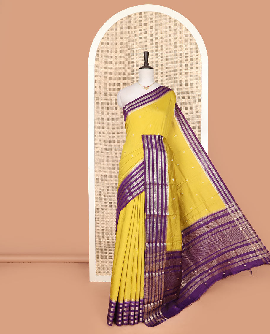 Yellow buttas assam silk saree, contrast traditional zari design border, and zari striped pallu