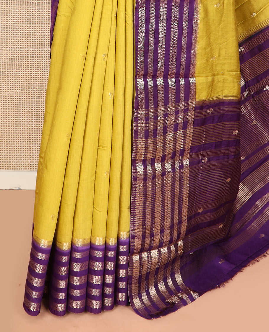 Yellow buttas assam silk saree, contrast traditional zari design border, and zari striped pallu