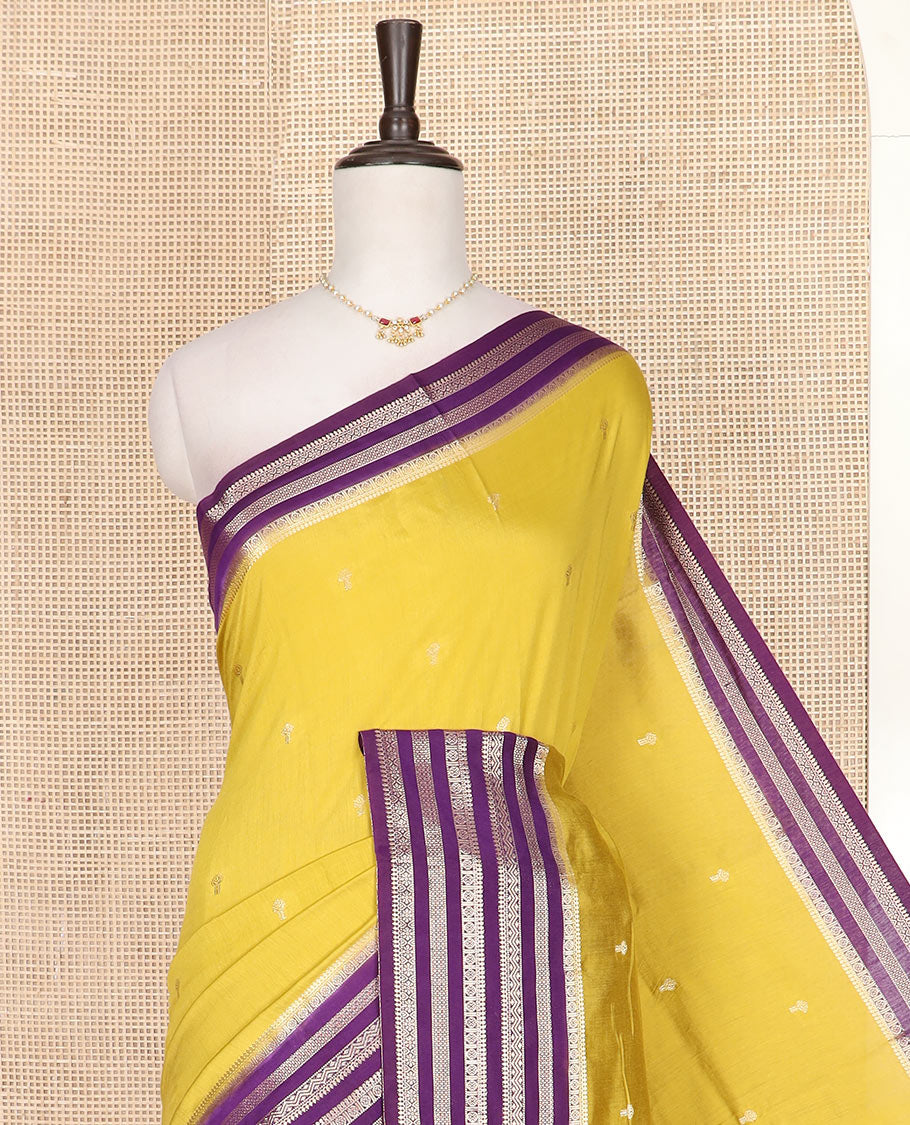 Yellow buttas assam silk saree, contrast traditional zari design border, and zari striped pallu
