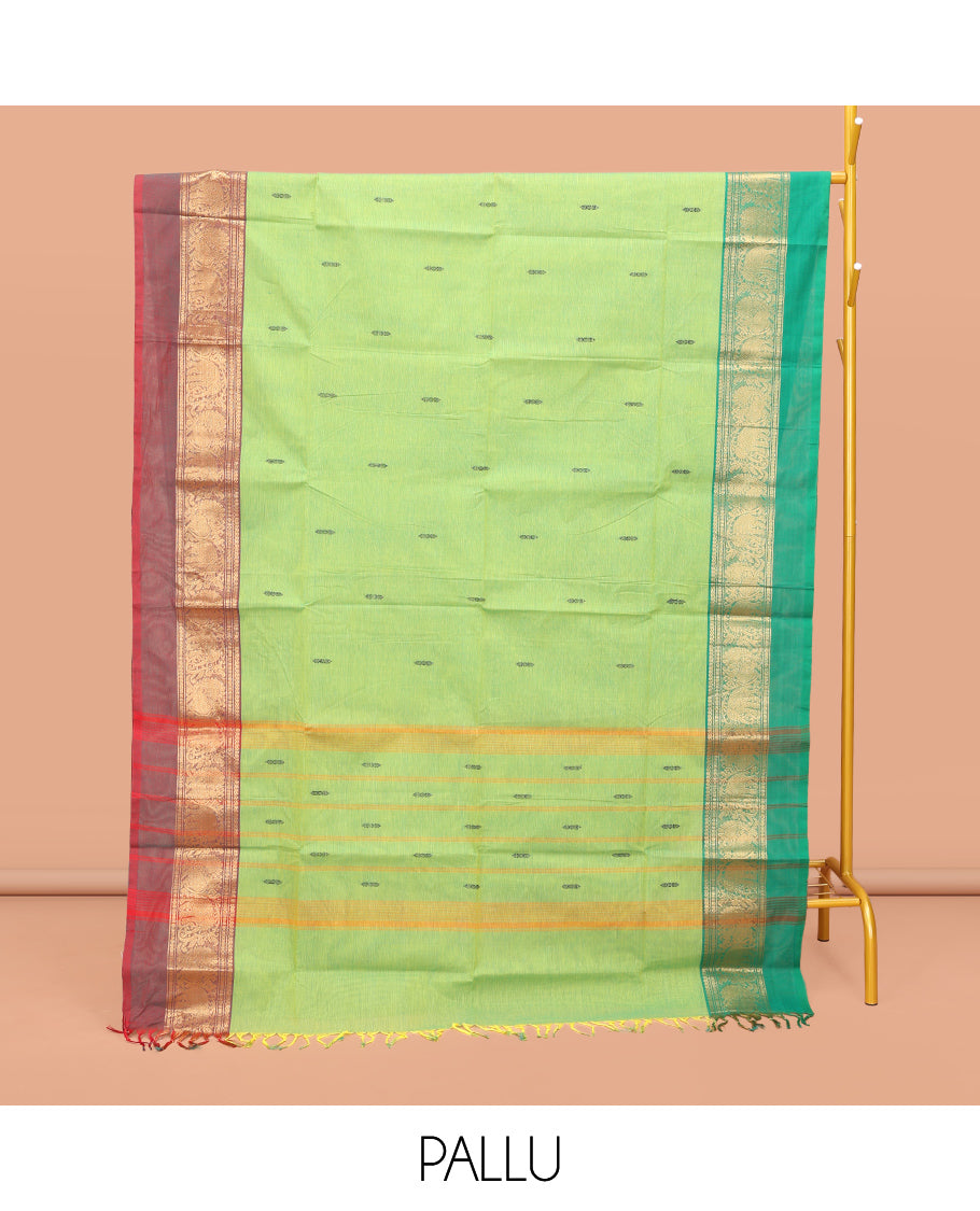 Pista Green Chettinad Cotton Saree, Decorated with Thread Buttas All Over Its Body, Complemented by a Contrast Ganga-Jamuna Kal Eragina Border of Kodi Peacock and Elephant Designs, Pallu of Buttas and Stripes, and Paired with a Matching Blouse