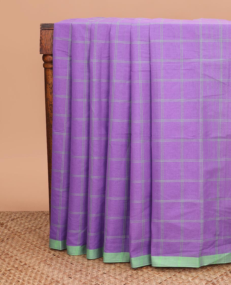 Purple checked Mangalagiri cotton saree with contrast border, striped pallu, and a contrast kalamkari floral printed blouse