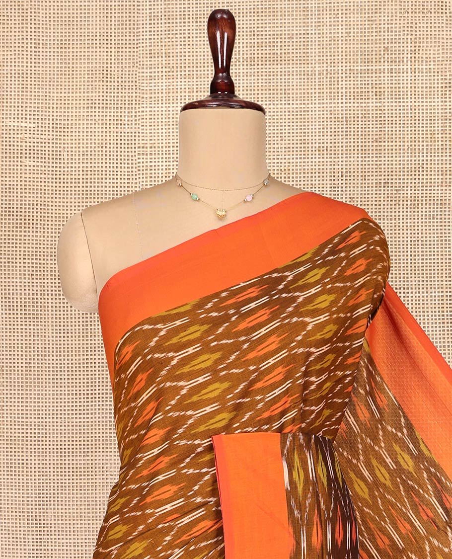 Brown Ikkat Cotton Saree, Decked Up with Ikkat-Style Ogee Patterns on Its Body, Complemented by Contrast Plain Border, Pallu Steeped with Ikkat Buttas, and Has No Blouse
