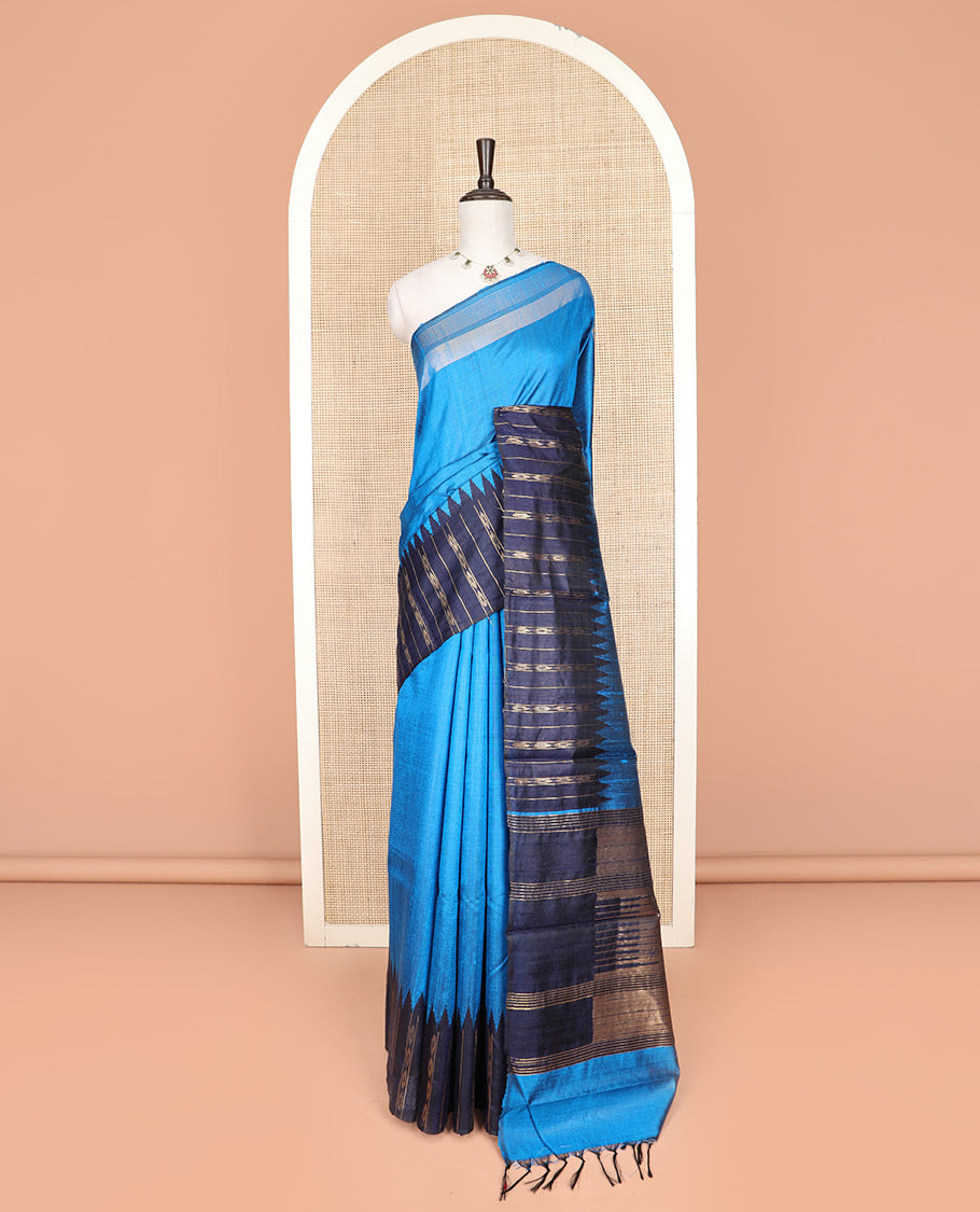 Blue Plain Dupion Silk Saree, Complemented by a Contrast Temple Border of Geometric Patterns, Zari-Rich Pallu of Temple Designs, and Paired with a Contrast Blouse