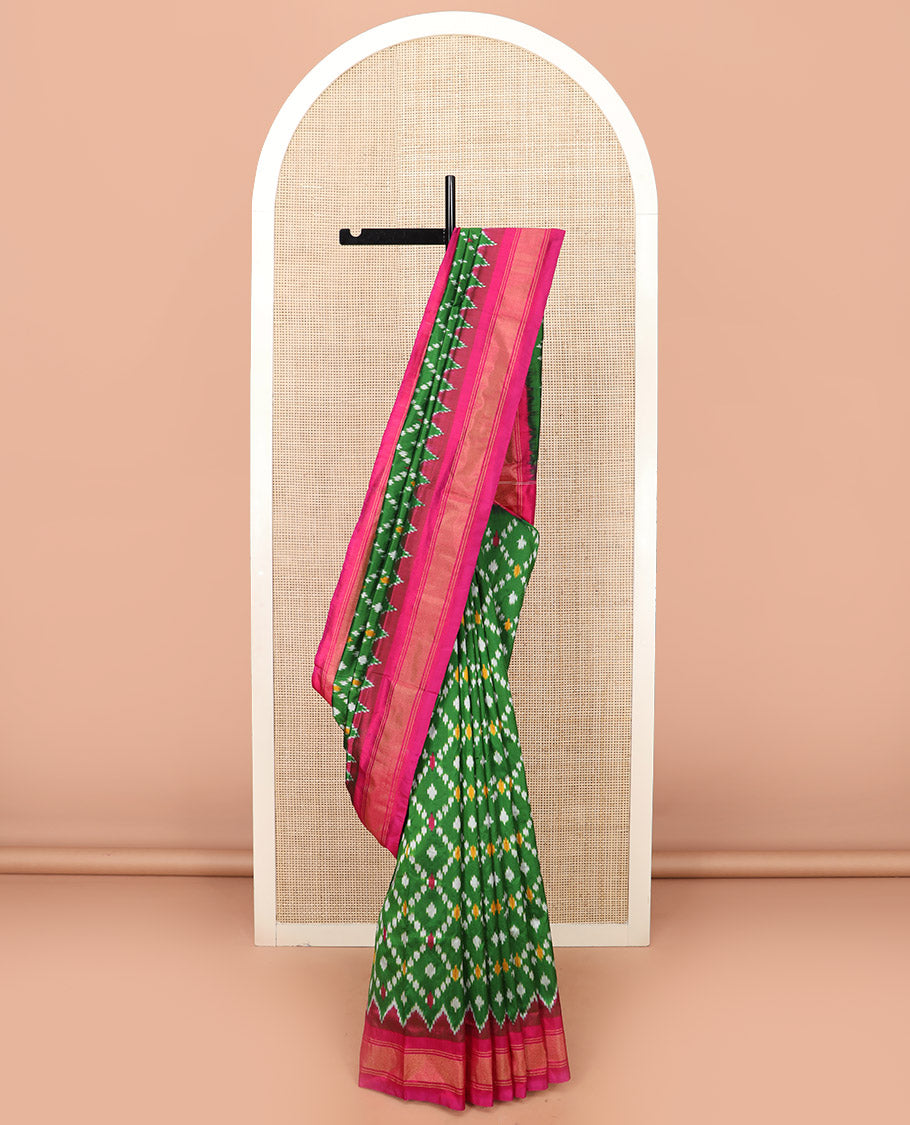 Green Ikkat Silk Saree with Ikkat Buttas Enclosed Jaal Design, Spotlighted with a Contrast Temple Border, Pallu Features Ikkat Jaal Patterns, and with a Contrast Blouse
