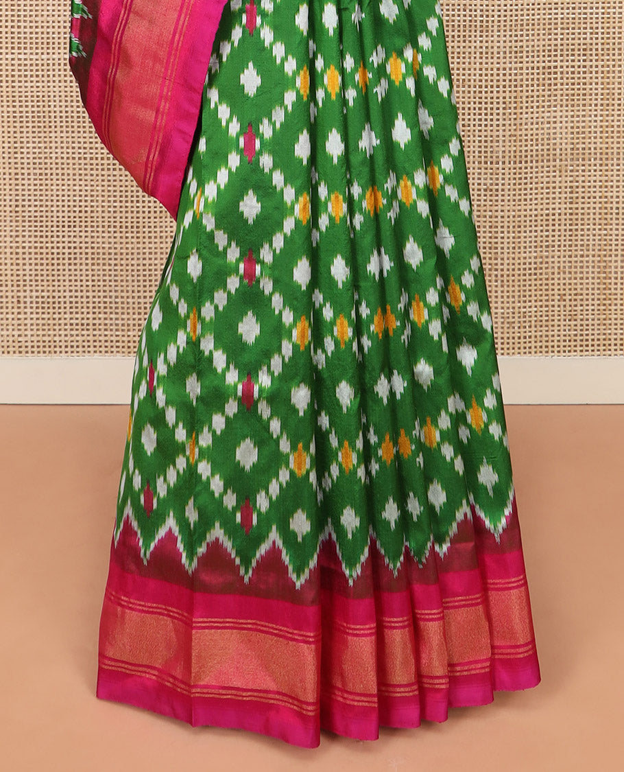 Green Ikkat Silk Saree with Ikkat Buttas Enclosed Jaal Design, Spotlighted with a Contrast Temple Border, Pallu Features Ikkat Jaal Patterns, and with a Contrast Blouse