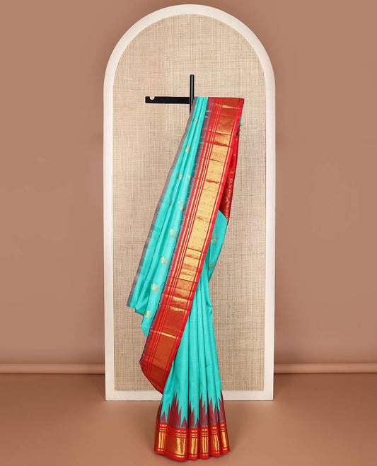 Turquoise yaanai buttas kanchipuram silk saree, contrast thazampoo rekku one-sided border of thilakam mokku,banaras & jaal & butta enclosed jaal pallu