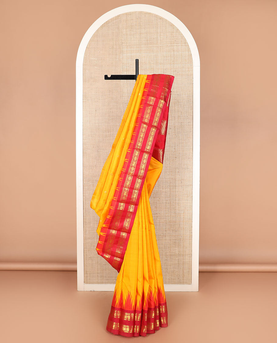 Yellow zari buttas Kanchipuram silk saree, contrast thazampoo rekku border of rekku, banaras, and mayil chakram designs, and zari design pallu